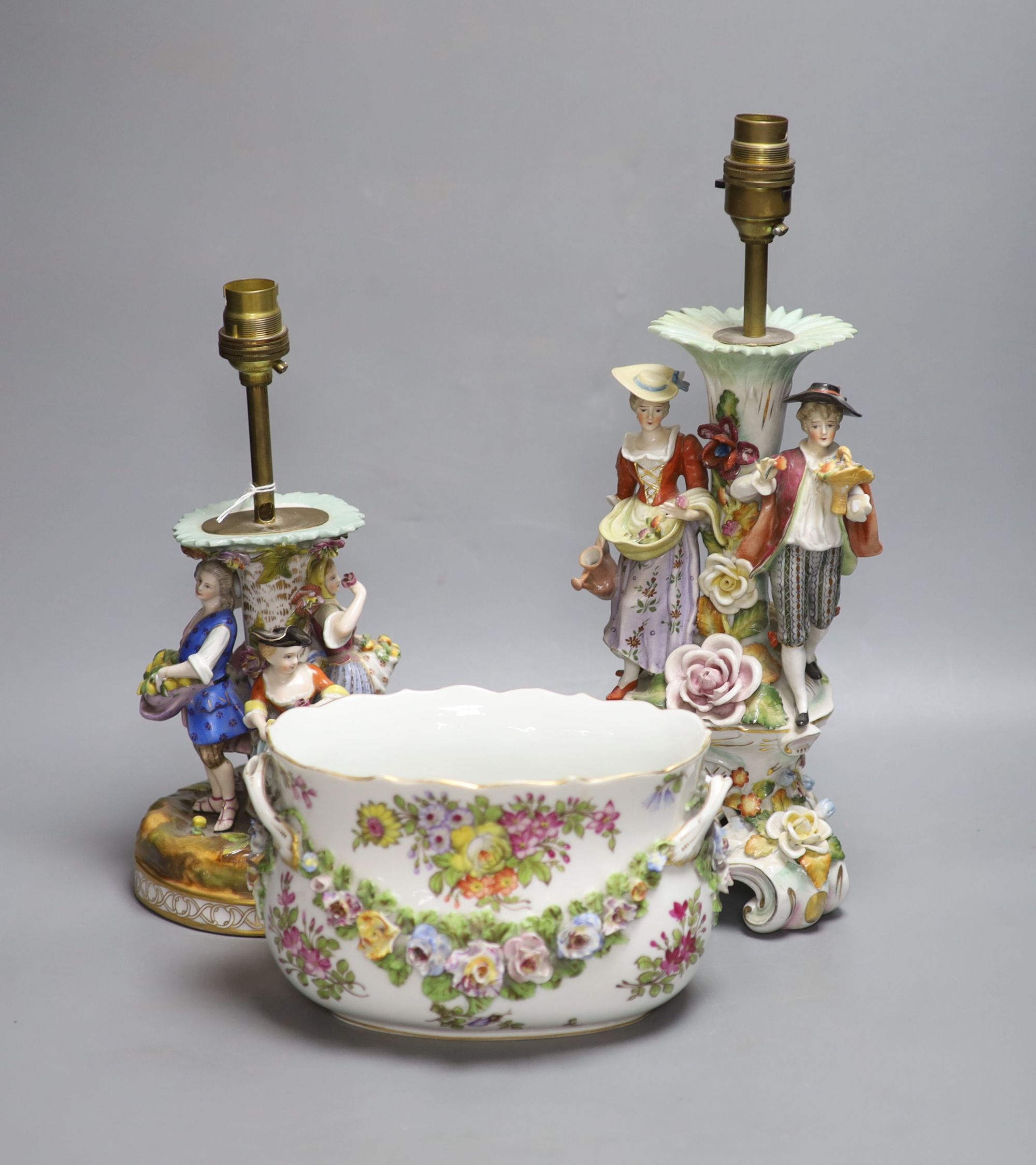 A Dresden figurative lamp, another similar lamp and a bowl with swags of flowers, tallest 28cm